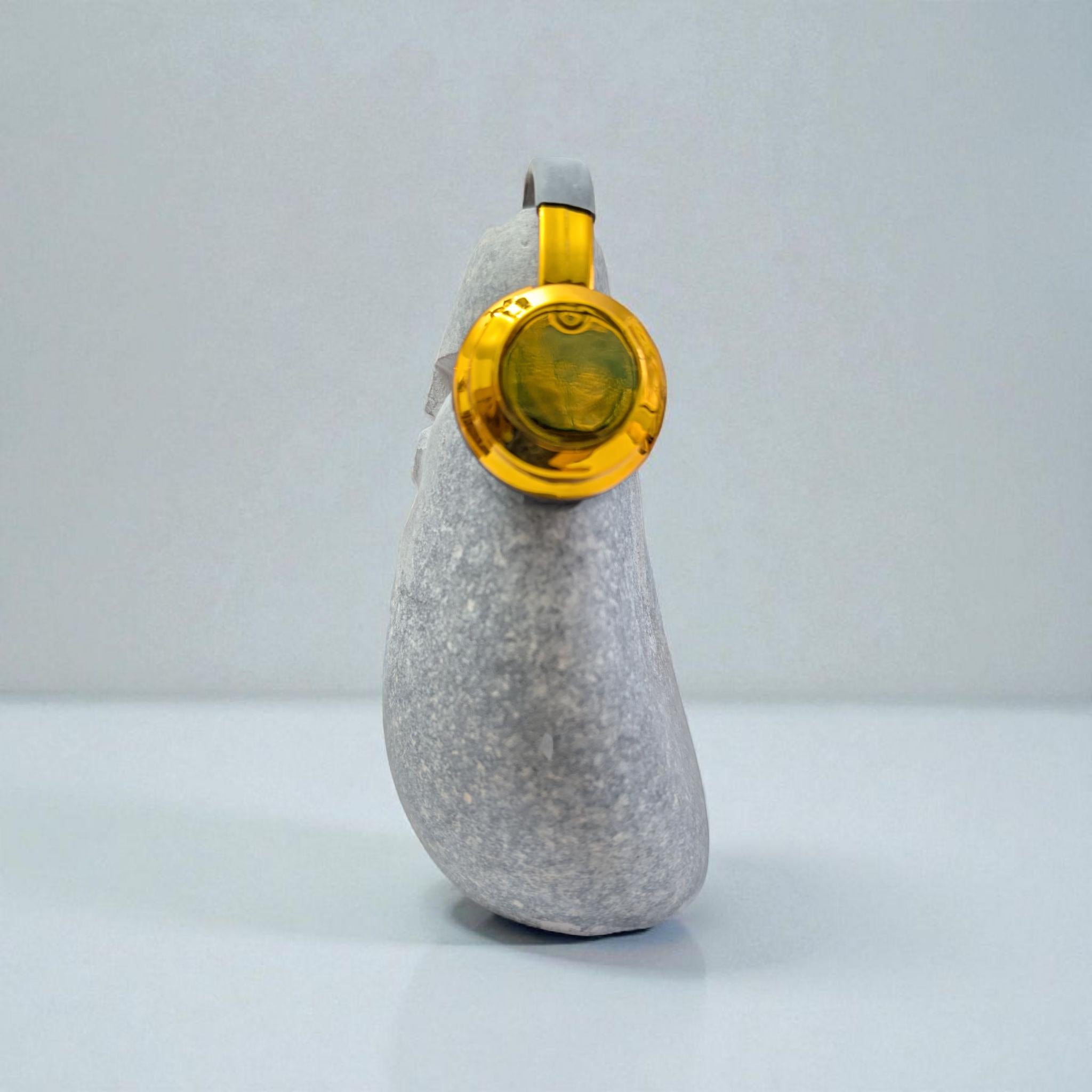 DJ OoF Limestone Sculpture: Hand-Carved Stone Decor with Green Headphones
