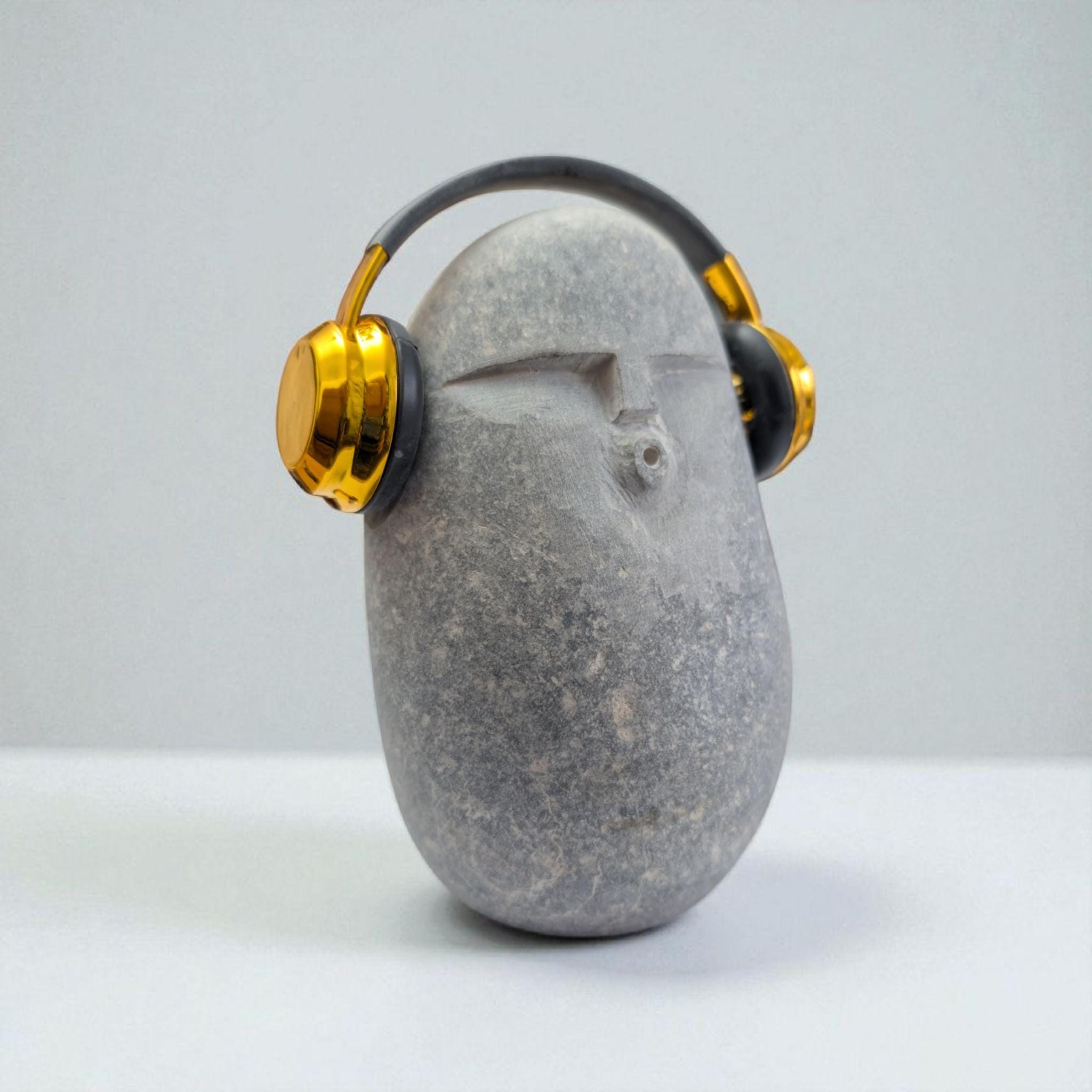 DJ OoF Limestone Sculpture: Hand-Carved Stone Decor with Green Headphones