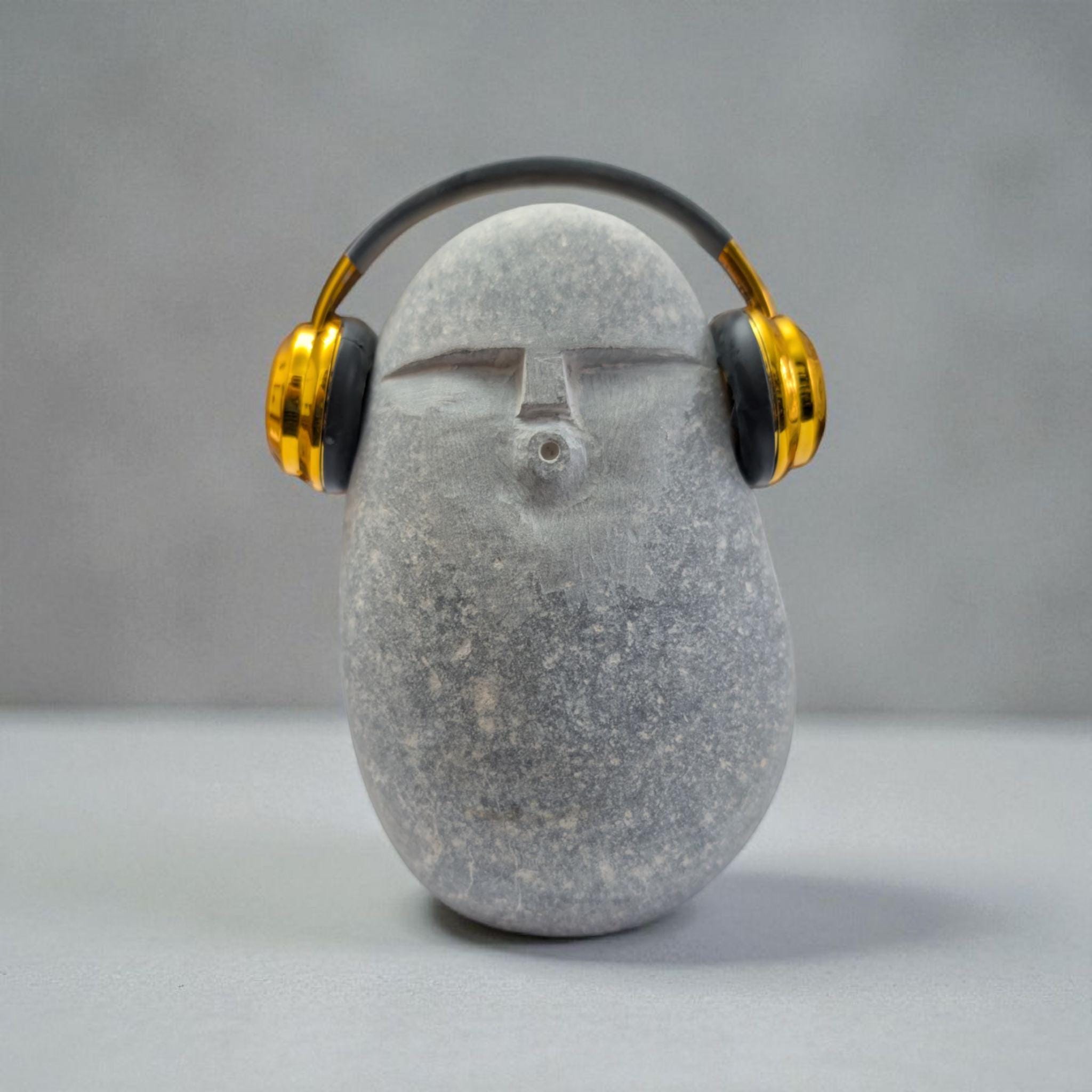 DJ OoF Limestone Sculpture: Hand-Carved Stone Decor with Green Headphones